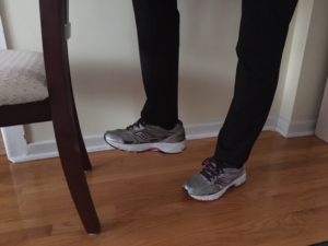 Senior stretching with help of chair
